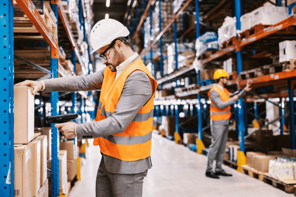 Two men in a warehouse scanning