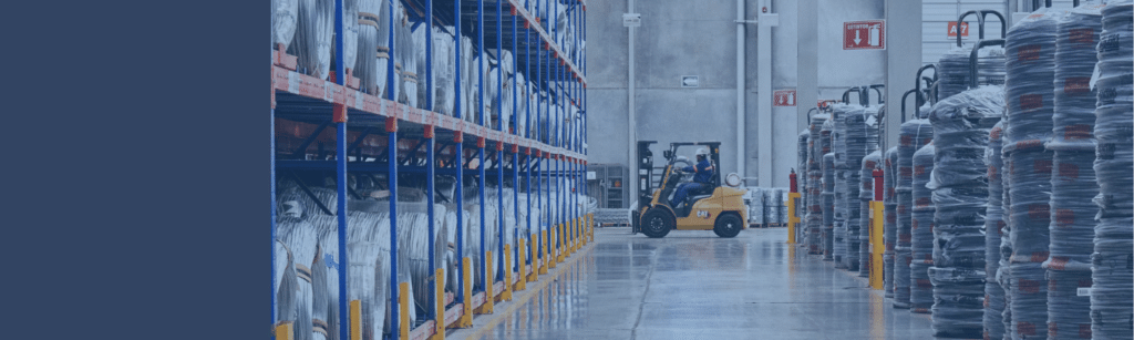 Forklift in large warehouse down a long aisle